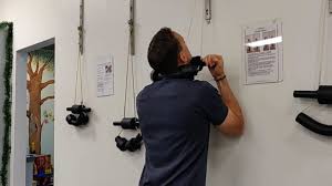 Patients perform cervical traction exercises prior to their chiropractic adjustment